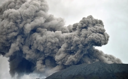 While the search is halted, an Indonesian volcano bursts, killing eleven hikers